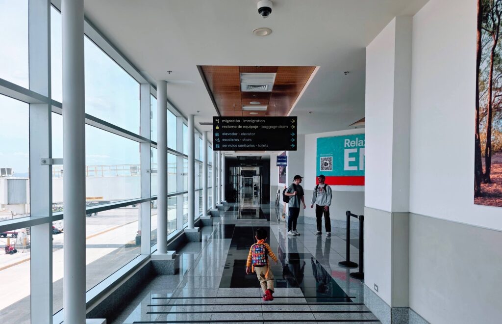 Liberia or San Airport - which to choose when flying to Costa Rica. Boy running through immigration lounge