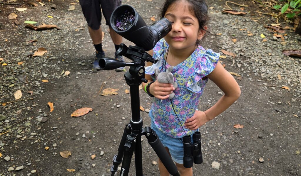 Kids observing a sloth through the scope at Bogarin Trail, La Fortuna