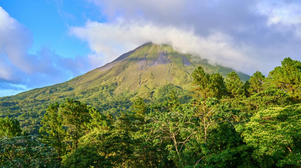All Places to go in Costa Rica - La Fortuna, Arenal Volcano looming over the town of La Fortuna