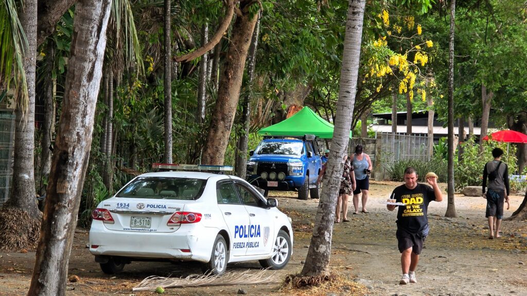 Is Costa Rica safe for families? - Police car parked on a Costa Rica tourist beach/ Playa Hermosa, the safest beach in Costa Rica